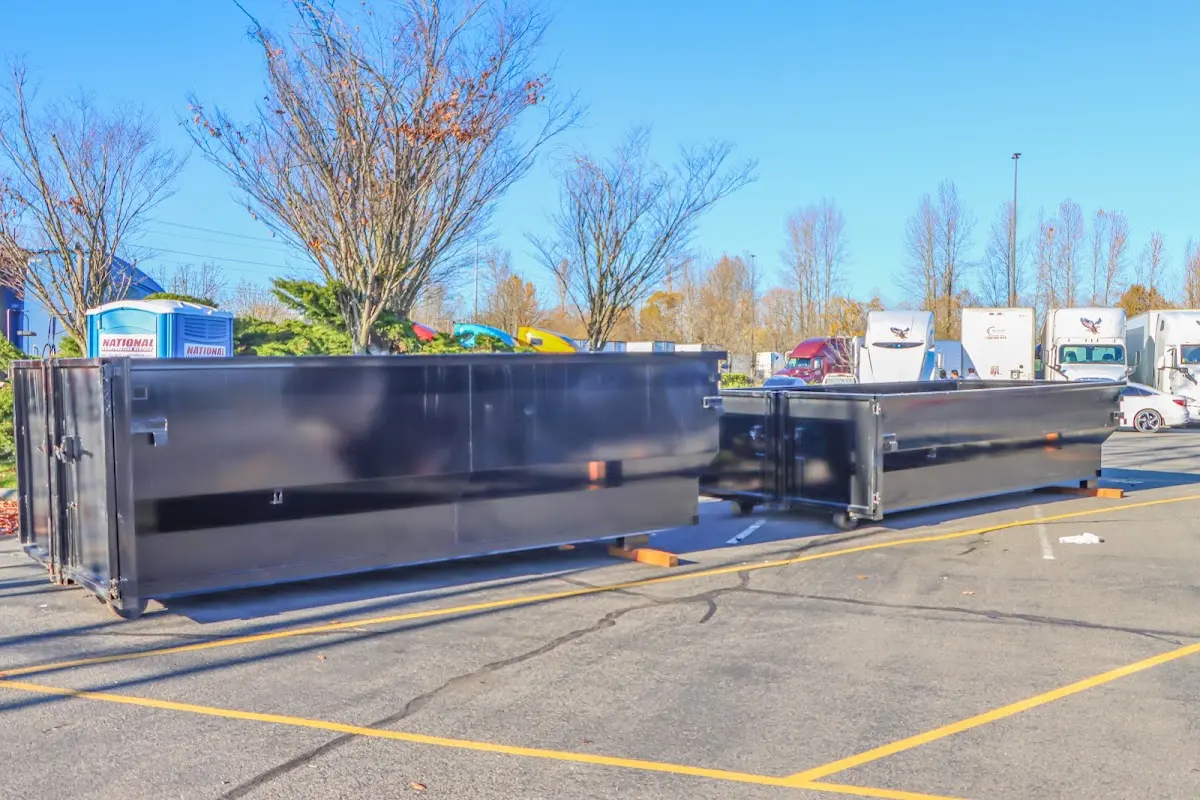 Professional dumpster rental service with roll-off container on residential driveway in Westlake